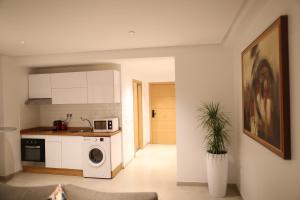 a kitchen with a washer and dryer in a room at Cozy Apartment with Veranda Downtown in Casablanca