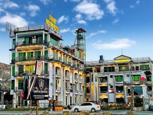 a building with a sign on the side of it at Swat Hilton Hotel by Khan Familia in Swat