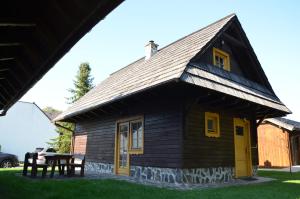 a small wooden house with a pitched roof at Chata Pod Jedľou in Liptovský Mikuláš
