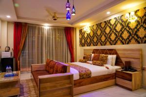 a bedroom with a king sized bed and a couch at Swat Hilton Hotel by Khan Familia in Swat