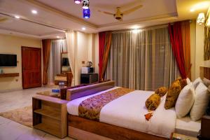 a bedroom with a large bed in a room at Swat Hilton Hotel by Khan Familia in Swat