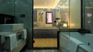 a bathroom with a sink and a shower and a tub at My Kent Hotel in Istanbul +109 photos