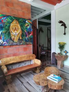 a room with a bench and a painting on the wall at POSADA KAUAI in Mocoa