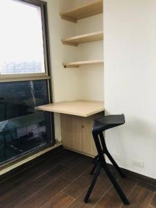 a desk and a chair in a room with a window at Apartamento Buenaventura in Buenaventura