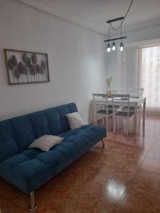 a living room with a blue couch and a table at Mi casa de Molina in Molina de Segura