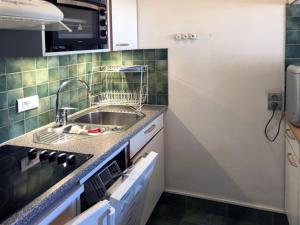 a kitchen with a sink and a counter top at 3 pièces au Val Claret avec parking et wifi, proche pistes - FR-1-449-169 in Tignes +6 photos