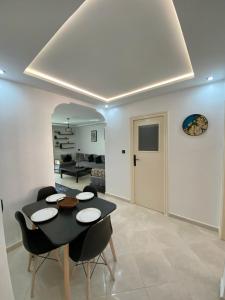 a living room with a dining room table and chairs at Lovely 2 bedroom apartment in Rabat