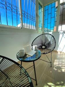 a table and a chair with a book and a laptop at Lovely 2 bedroom apartment in Rabat