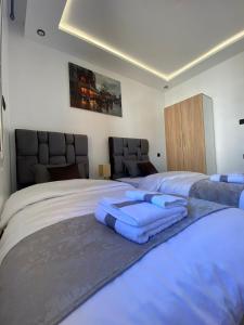 a bedroom with two beds with blue towels on them at Lovely 2 bedroom apartment in Rabat