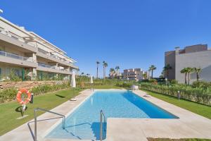 a swimming pool in front of a building at Luxury Penthouse at La Cala Golf in La Mairena