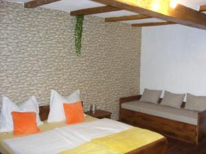 a bedroom with two beds with orange pillows at Apartment Bodza in Tompa