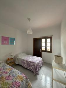 1 dormitorio con 2 camas y ventana en Casa Barrera en Tigaday