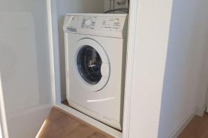 a washer and dryer in a corner of a room at Katwijk Center, 1 min away from the beach! in Katwijk aan Zee