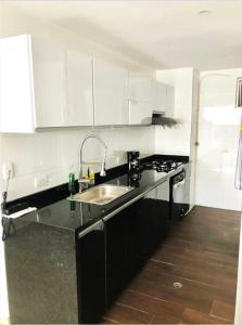 a kitchen with a sink and a stove top oven at Apartamento Buenaventura in Buenaventura