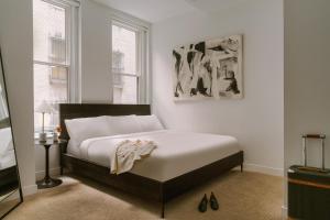 a bedroom with a large bed with white sheets at Sonder The Witherspoon in Philadelphia