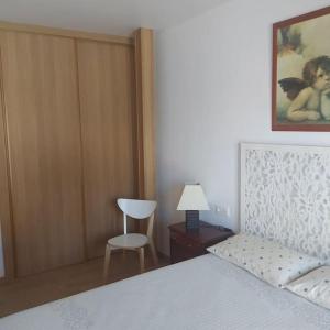 a bedroom with a bed and a chair and a table at El Campanario. Villoria (Salamanca). in Villoría