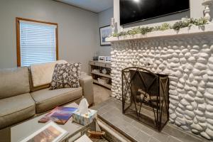 a living room with a couch and a fireplace at Cozy Erie Vacation Rental with Patio and Seasonal Pool in Erie