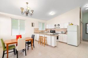 a kitchen and dining room with a table and chairs at Villa Ensueno a 3 bdr house in the mountain in Rincon