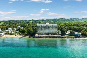 an aerial view of a hotel on a beach at Beacfront Petite Paradise unit at Pelican Reef 103 in Rincon