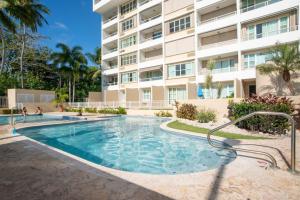 a swimming pool in front of a building at Beacfront Petite Paradise unit at Pelican Reef 103 in Rincon