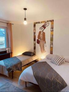 1 dormitorio con 2 camas y una pintura de un conejo en LA MARIEFACTURE - Comme c'est tout bêtes !, en Faulquemont