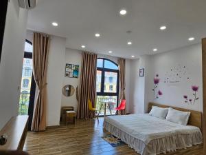 a bedroom with a bed and a large window at Homestay ánh chi in Phú Quốc