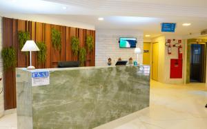 a lobby of a hospital with a reception counter at Atlântico Praia Hotel in João Pessoa