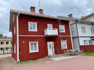 a red house with a table in front of it at Penthouse close to Vasaloppet finish line portal in Mora