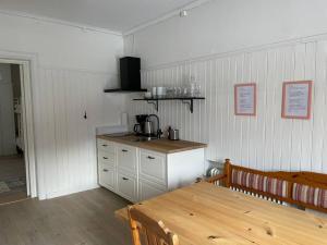 a kitchen with a table and a sink and a counter at Skraddaren, close to Vasaloppet finish line portal in Mora