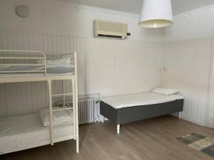 a room with two bunk beds and a fan at Skraddaren, close to Vasaloppet finish line portal in Mora