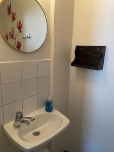 a bathroom with a sink and a mirror on the wall at Skraddaren, close to Vasaloppet finish line portal in Mora