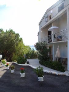 a building with potted plants in front of it at Vila Marija-Roza in Drage