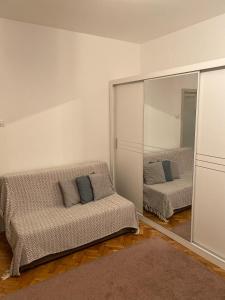 a living room with two beds and a mirror at Apartment Tilia Center Belgrade in Belgrade
