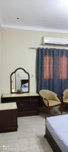 a bedroom with a mirror and a bed and a dresser at Banna House in Abu Simbel