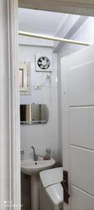 a white bathroom with a sink and a toilet at Banna House in Abu Simbel