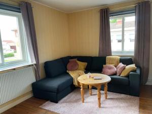 a living room with a blue couch and a table at Skomakaren, near Vasalopp finish line portal in Mora in Mora