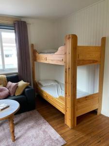 a couple of bunk beds in a room with a couch at Skomakaren, near Vasalopp finish line portal in Mora in Mora