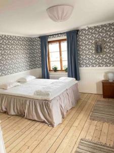 a bedroom with a large bed and a window at MoraTelegrafen in central Mora in Mora