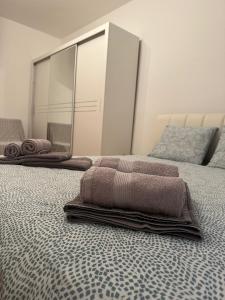 a bedroom with two beds with towels on them at Apartment Tilia Center Belgrade in Belgrade