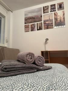 a bed with two towels on top of it at Apartment Tilia Center Belgrade in Belgrade