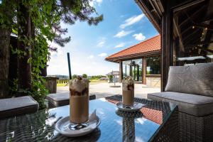 two milkshakes sitting on a table on a patio at Hotel i Restauracja Stara Kuźnia in Dobczyce