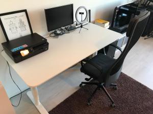 an office desk with a computer monitor and a chair at Modern Studio, free parking & wifi, Aino Areena 300m in Järvenpää