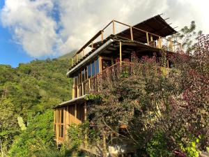 a building on top of a hill with trees at SelvaMinca in Minca