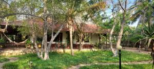 a house with trees in front of it at Villa Befasika in Toliara