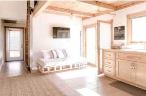 a large room with a bed and a sink and a counter at Oasis East Sac Charming Home with Saltwater Pool and Casita in Sacramento +24 photos