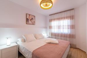 a white bedroom with a bed and a window at Panarea Agua Viva in Callao Salvaje +13 photos