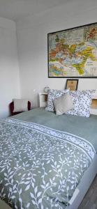 a bedroom with a large bed with a map on the wall at Sòlfar - Amiens (hypercentre) in Amiens