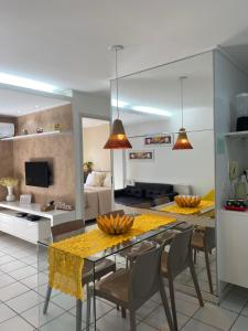 a kitchen and dining room with a table and chairs at Beira Mar Apartmento 306 in Maceió