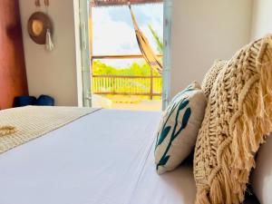a bedroom with a bed with a view of a porch at Casa Celeste in Atins