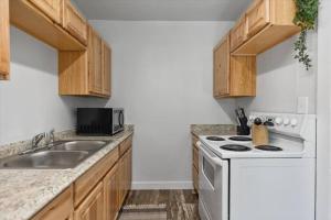 a kitchen with a white stove and a sink at 216: Lovely 1 bedroom close to amenities! in Billings